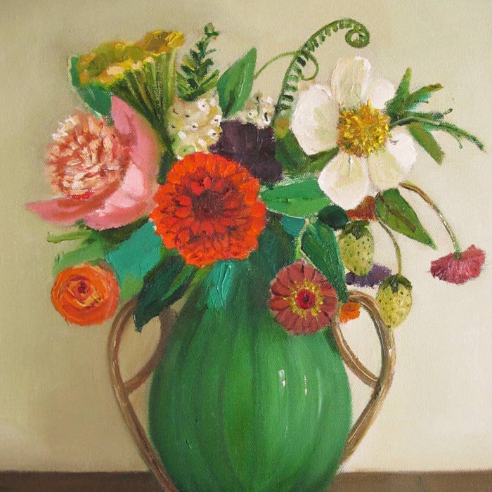 Colorful bouquet of flowers in a green vase against a plain background