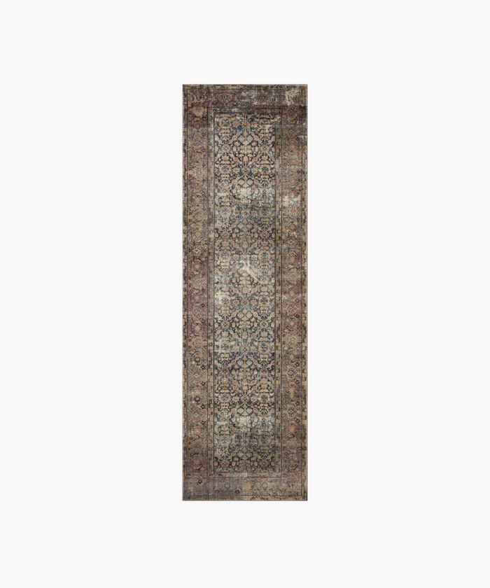 A vintage inspired runner with intricate floral and geometric patterns in muted blues, reds, and browns. It exudes a sense of classic elegance and warmth.