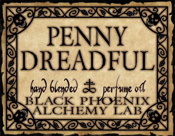 Label for 'Penny Dreadful' hand blended perfume oil by Black Phoenix Alchemy Lab with decorative border.