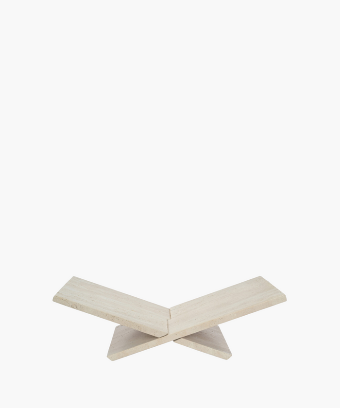 Neutral travertine bookstand with sculptural form. | SW Home