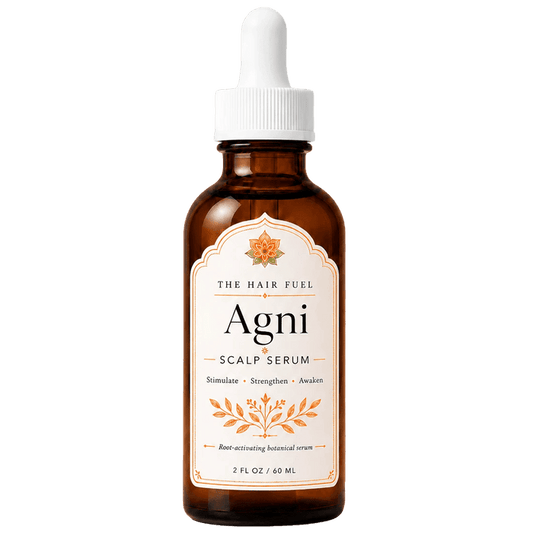 A 2 fl oz amber glass dropper bottle of The Hair Fuel Agni Scalp Serum, featuring a white dropper cap and a cream-colored label with orange botanical illustrations.