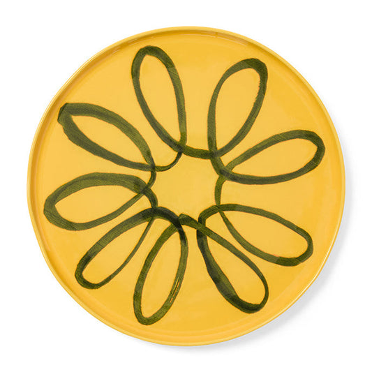 Yellow plate with green abstract design on a white background