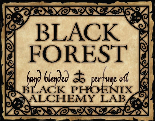 Label for Black Forest perfume oil by Black Phoenix Alchemy Lab with decorative border.