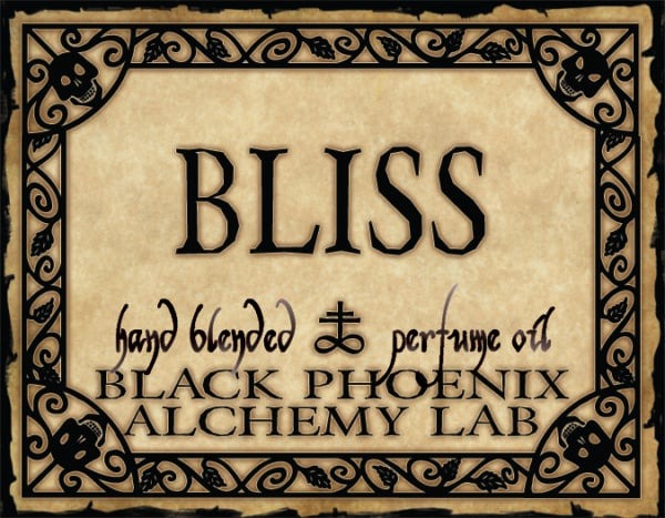 Label for 'Bliss' hand blended perfume oil by Black Phoenix Alchemy Lab with decorative border.