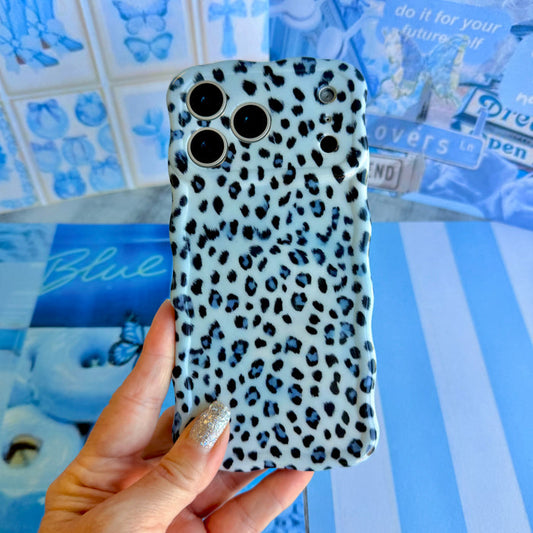 Trendy light blue wavy iPhone case featuring a high-contrast leopard print in dark blue and sapphire with a high-gloss finish.