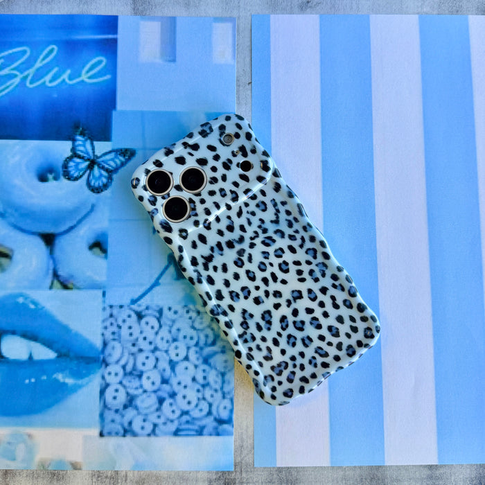 Trendy light blue wavy iPhone case featuring a high-contrast leopard print in dark blue and sapphire with a high-gloss finish.