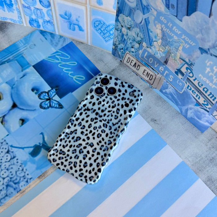 Trendy light blue wavy iPhone case featuring a high-contrast leopard print in dark blue and sapphire with a high-gloss finish.