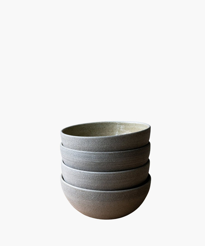 Stack of gray ceramic bowls on a white background. | SW Home