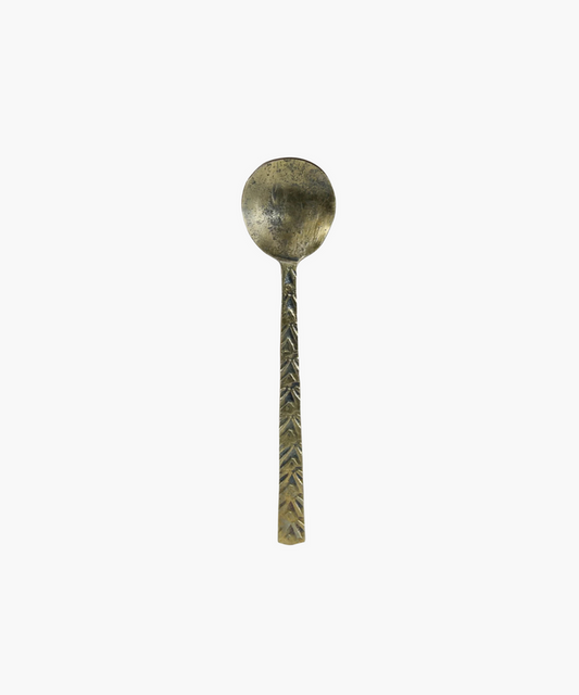 Antique inspired metal spoon with a textured handle featuring a leaf pattern. The spoon has a tarnished, rustic appearance, evoking a sense of history and nostalgia. | Wildwood Home Co.