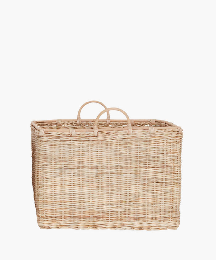A large, square rattan basket with two rounded handles in a natural finish.  The light brown weaving creates an earthy, natural look suitable for storage or decor. | Wildwood Home Co.