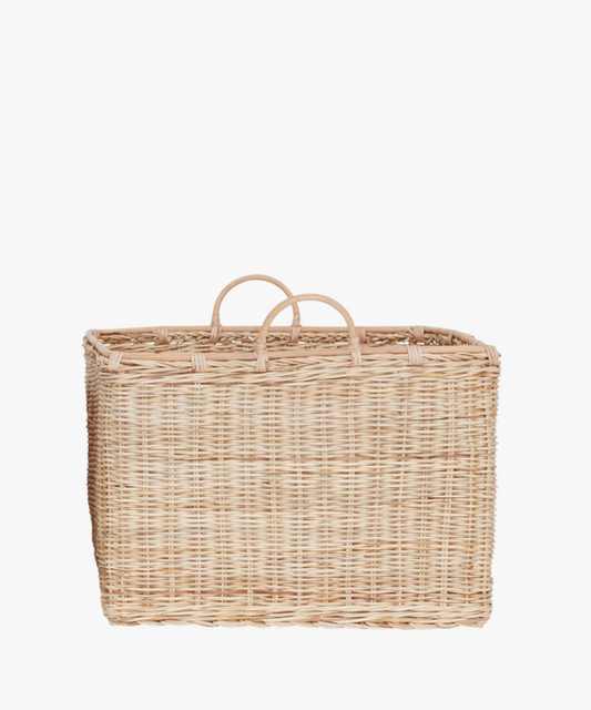 A large, square rattan basket with two rounded handles in a natural finish.  The light brown weaving creates an earthy, natural look suitable for storage or decor. | Wildwood Home Co.