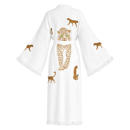 A white cotton kimono robe with wide sleeves and fringed edges, featuring embroidered leopard designs in brown and gold on the back.