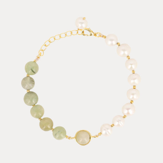 a bracelet with pearls and a gold chain