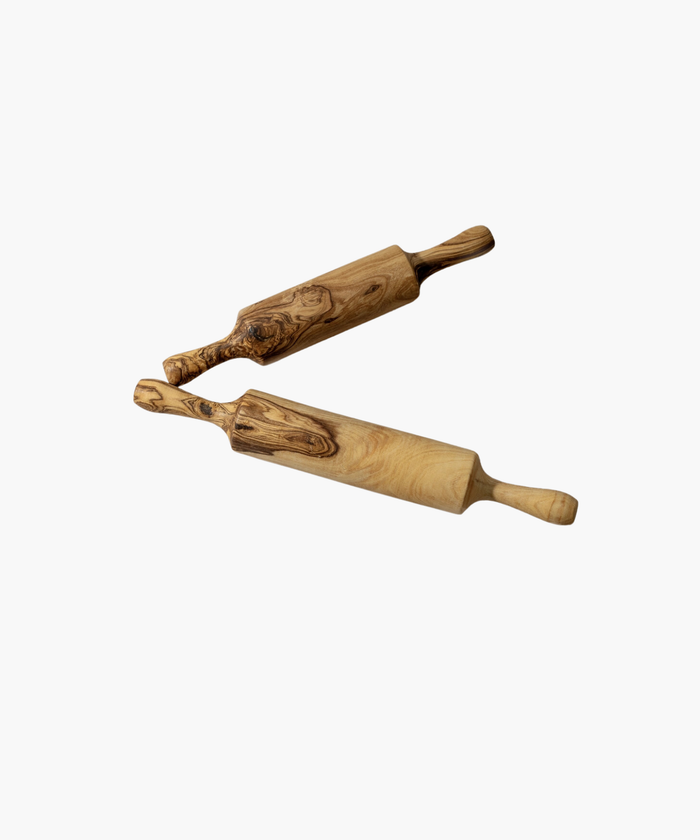 Two wooden rolling pins of different sizes with distinct dark grain patterns and smooth handles, set against a white background, conveying a rustic and natural aesthetic. | Wildwood Home Co.