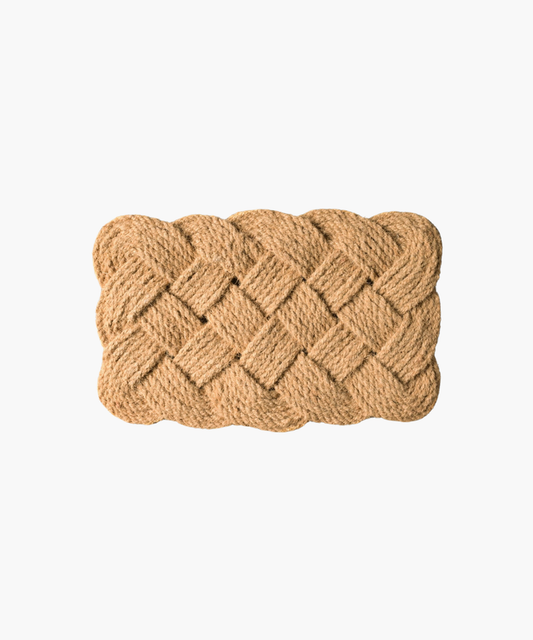 A rectangular doormat with an intricate braided pattern crafted from natural jute fibers, conveying a rustic and welcoming tone. | SW Home