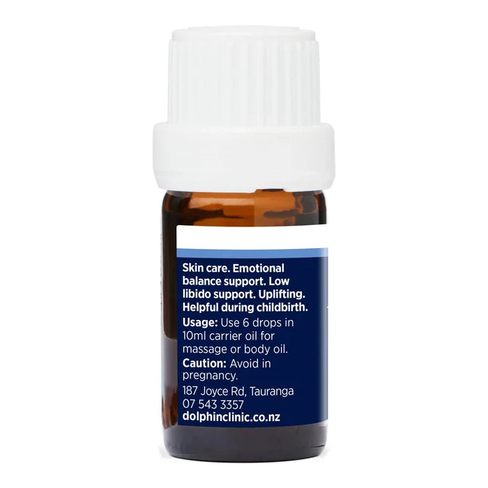 Back view of bottle of rose essential oil with label on a white background. Usage instructions with cautions.