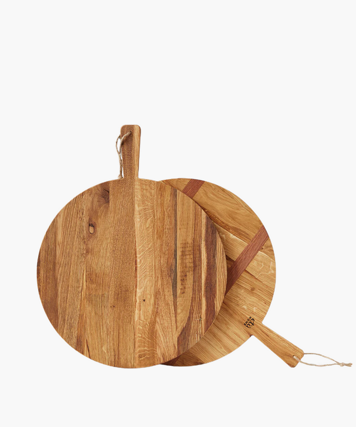 Two round wood cutting boards overlap on a white background, featuring natural wood grain and handles with hanging loops, conveying a rustic kitchen feel. | SW Home