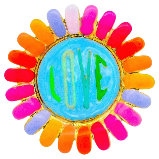 Colorful brooch with 'LOVE' text on a white background