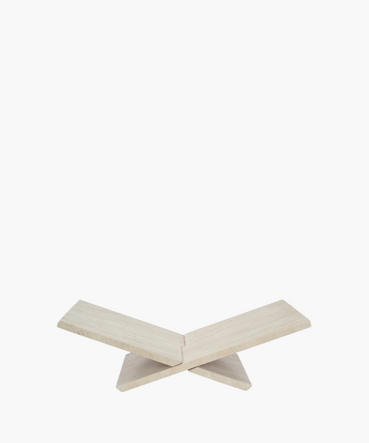 Neutral travertine bookstand with sculptural form. | SW Home