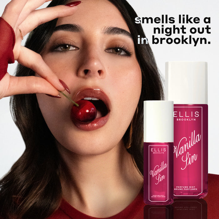 Model with brown hair and red nails wearing red shirt and gold earrings eats a cherry on white background with bottles of VANILLA SIN 240ml and 90ml and black and white text that reads "smells like a night out in brooklyn."