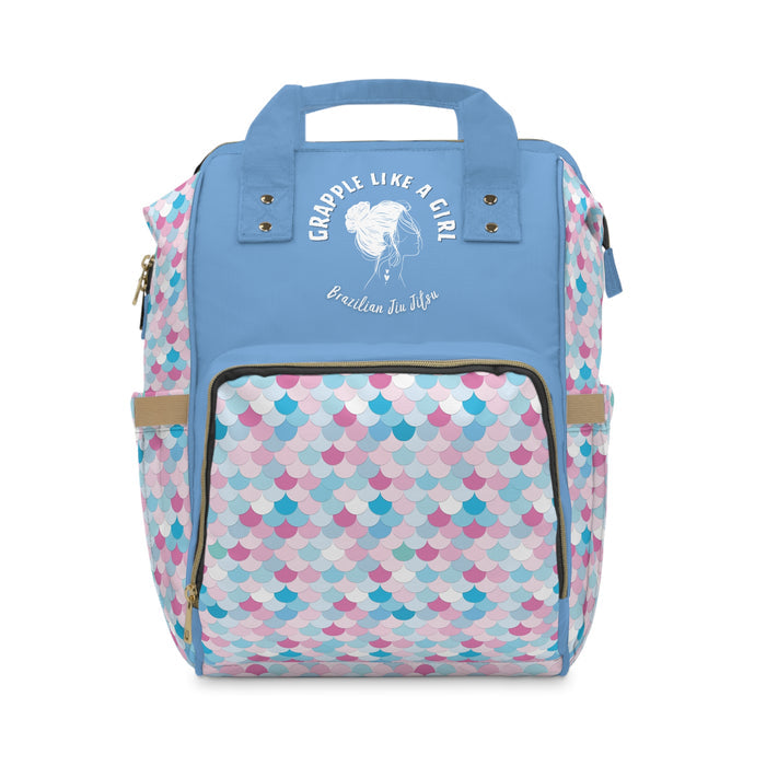 Backpack with colorful pattern and blue top section on a white background