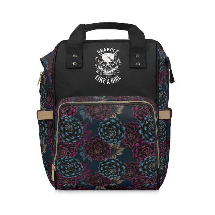 Floral backpack with black top section and 'Grapple Like a Girl' logo on a white background